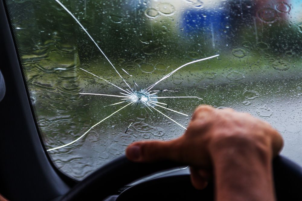 Technician repairing a long windshield crack in McKinney, TX using resin injection
