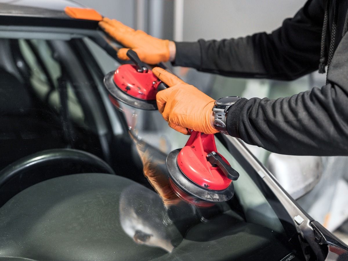 Windshield Chip Repair Prosper TX technician repairing a small rock chip on a car windshield.